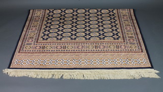 A blue ground Bokhara style Belgian cotton carpet 88" x 63"