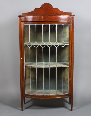 An Edwardian mahogany bow front display cabinet with leaded glass door, raised on square tapered legs 65" x 33" x 16"