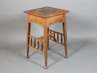 A Liberty style Arts & Crafts square oak occasional table with tiled top, raised on square tapering supports united by an H framed stretcher 28"h x 17"w x 17"d 