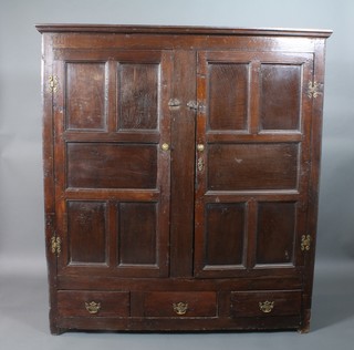 A 17th/18th Century oak cupboard of panelled construction, the base fitted 3 short drawers 66"h x 60"w x 20 1/2"d 