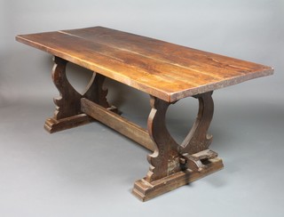 An elm refectory table with plank top, raised on a shaped base with H framed stretcher 29"h x 73"w x 21 1/2"d