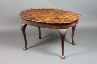 A Queen Anne style oval walnut occasional table with pie crust edge on cabriole supports 36"h x 26"w x 40"d