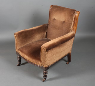 A 19th Century mahogany framed bedroom chair, upholstered in brown velvet, raised on turned tapered legs and casters 