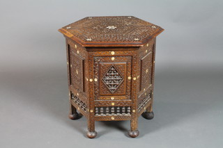 A Moorish carved hardwood octagonal coffee table, inlaid mother of pearl, raised on bun feet 23"h x 24"w x 21"d 