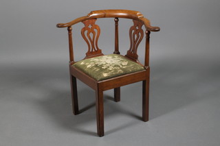 A Georgian mahogany corner chair with pierced back and drop in seat on square legs
