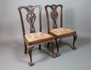 A pair of 19th Century carved mahogany Chippendale style slat back dining chairs with upholstered drop in seats, on cabriole, claw and ball supports