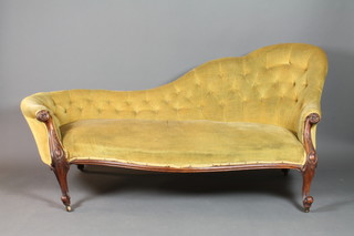 A Victorian carved mahogany show frame sofa upholstered in yellow buttoned back draylon, raised on cabriole supports 95"h x 74"w x 30"d 