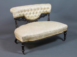 A Victorian ebonised sofa upholstered in yellow material with brass casters (back left hand leg f and r) 