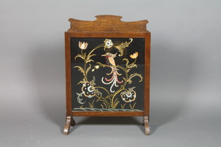 A 1930's shaped oak firescreen with tapestry panel to the centre depicting a bird 28" x 20" 