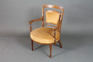 An Edwardian inlaid mahogany open arm chair, raised on square tapering supports inlaid satinwood stringing