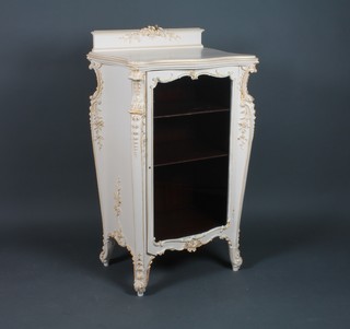 An Edwardian French Louis style carved and painted display cabinet with raised back, fitted shelves enclosed by a panelled door, raised on carved supports 42 1/2"h x 24"w x 18"d 