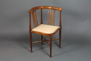 An Edwardian inlaid mahogany corner chair with upholstered seat, raised on turned supports 