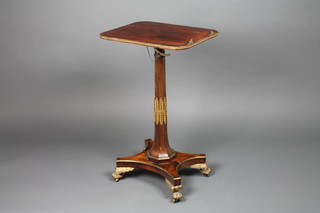 A fine Regency rosewood and brass mounted reading occasional table, with rounded rectangular top having brass beading raised on an octagonal fluted column with acanthus brass mouldings on a brass mounted quatrefoil base terminating in winged, claw, brass feet 29"h x 14" x 18" 