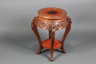 An Oriental circular carved hardwood 2 tier jardiniere stand on cabriole supports 23"h x 14" diam.