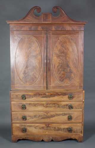 A handsome Georgian inlaid mahogany linen press with broken pediment, the upper section fitted 2 shelves enclosed by a pair of oval panelled doors, the base fitted 3 long drawers with ivory escutcheons and brass circular drop handles 88"h x 50"w x 22"d