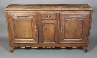 An 18th Century French elm dresser base fitted a drawer flanked by a pair of cupboards, raised on cabriole legs, 38"h x 65"w x 18"d