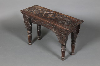 A Victorian rectangular heavily carved oak stool raised on turned supports 17"h x 27"w x 10"d