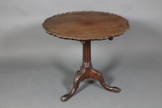 A 19th Century Chippendale style circular snap top tea table with pie crust edge raised on a turned and fluted column with tripod base 28"h x 32"d 