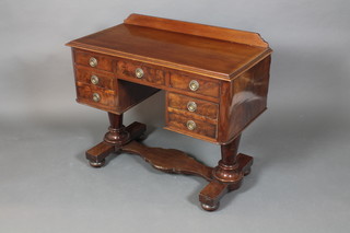 A Victorian mahogany dressing table with raised back fitted a drawer flanked by 6 short drawers, raised on turned supports united by an H  framed stretcher 33"h x 38 1/2"w x 19"d 
