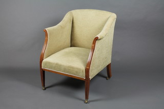 An Edwardian inlaid mahogany show frame armchair upholstered in green material, raised on square tapering supports
