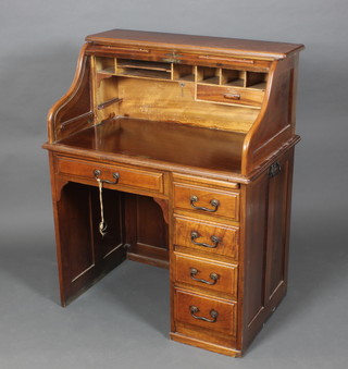 A Victorian mahogany roll top desk fitted 1 long drawer flanked by 2 short drawers with brass swan neck drop handles 45 1/2"h x 36"w x 24"d 