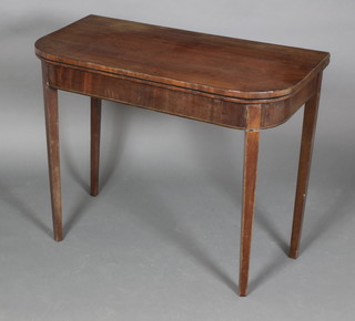 A Georgian mahogany D shaped card table with ebony and satin stringing, raised on square tapering supports 29"h x 36"w x 18"d