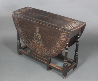 A Victorian oval carved oak drop flap gateleg dining table, the flaps with coat of arms 28"h x 39"w x 12"