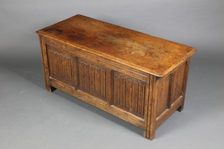 A carved oak coffer with linenfold decoration and hinged lid 20"h x 42"w x 18"d
