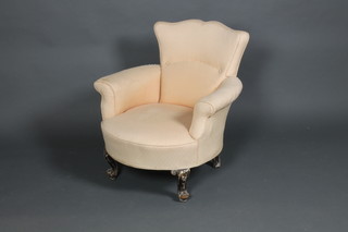 A Victorian tub back chair raised on French cabriole supports