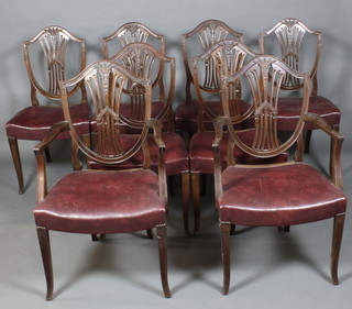 A set of 8 19th Century Hepplewhite style mahogany shield back dining chairs, 2 with arms, the seats upholstered in rexine, raised on square tapered legs
