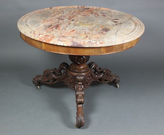 A Victorian walnut centre table raised on a heavily carved pillar and tripod support with veined marble top 28 1/2"h x 40" diam.