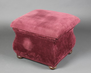 A square ottoman raised on bun feet upholstered in red material 15"h x 20"w x 19"d