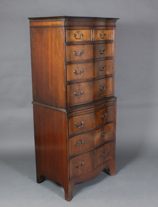 A Georgian style mahogany chest on chest of serpentine outline with moulded and dentil cornice, the upper section fitted 2 short and 3 long drawers, the base fitted a brushing slide above 3 long drawers raised on bracket feet 63 1/2"h x 28 1/2"w x 19"d