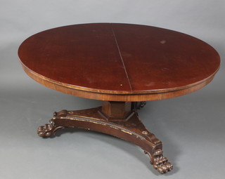 A William IV circular mahogany snap top breakfast table, raised on an octagonal column with triform base and paw feet 30"h x 55" diam.
