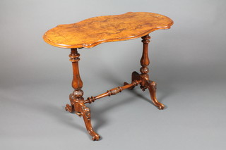 A Victorian oval shaped figured walnut centre table, raised on turned columns with H framed stretcher and squab feet 126 1/2"h x 36"w x 19"d 