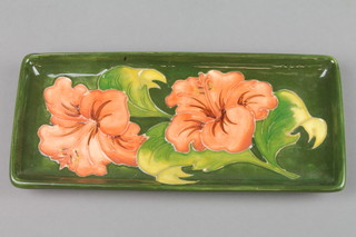 A Walter Moorcroft rectangular green ground tray decorated hibiscus, with impressed marks 8"