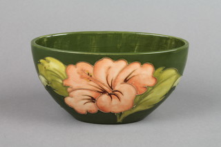 A Walter Moorcroft 1940's ovoid green ground bowl decorated with hibiscus, with printed label 6.5"