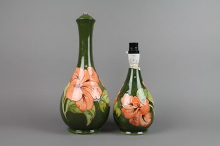 A Moorcroft baluster table lamp with green ground and hibiscus decoration, impressed marks 14" and a ditto 7", f, 