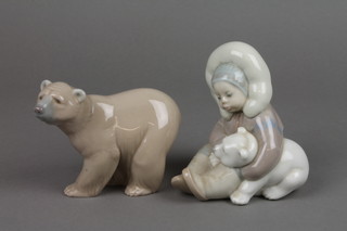A Lladro figure of an Eskimo child and polar bear cub 5" and a ditto of a polar bear 4"