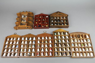 A collection of decorative thimbles in cases