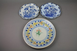 A Quimper bowl decorated with stylised flowers 12", a pair of Delft style plates