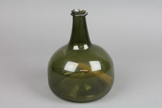An early 18th Century green glass squat wine bottle 7"