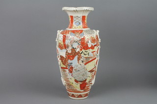An early 20th Century Satsuma vase decorated with figures in pavilions with stylised ribbon handles 15", f, 