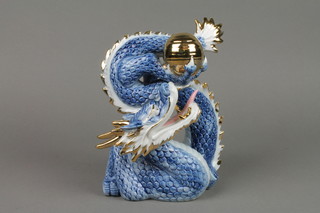 A 20th Century figure of a dragon chasing the flaming pearl with blue and gilt decoration 7"