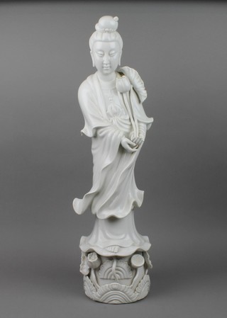 An early 20th Century blanc de chine figure of Guan Yin on a raised floral base 25"