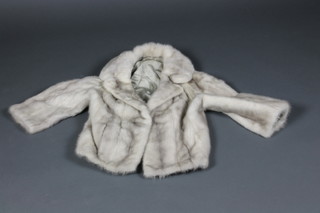 A lady's silver fur jacket