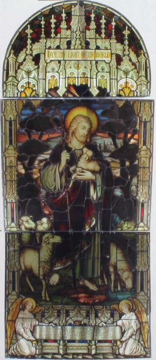 Charles Moore of 4 Bedford Place London, a 3 section stained glass window "I am the Life of the World" depicting a standing Christ with sheep, the base with dedication panel dated 1925, overall height, approx. 8ft x 43 3/4, repaired in 2010 