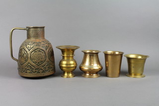 An embossed brass jug 9 1/2", a 19th Century brass mortar 3", a brass beaker 4" and 2 brass vases