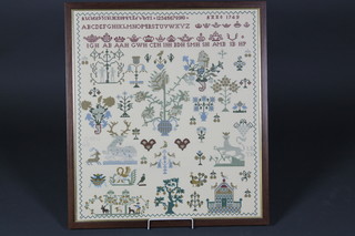 A 20th Century stitchwork sampler with alphabet and numbers, decorated trees and animals 26" x 23"