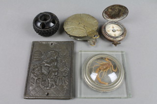 A turned bog oak pen rest 1", a cast lead plaque decorated a musician 4", a gilt metal paperweight in the form of a leaf, a pocket compass and a section of perspex set a scorpion 